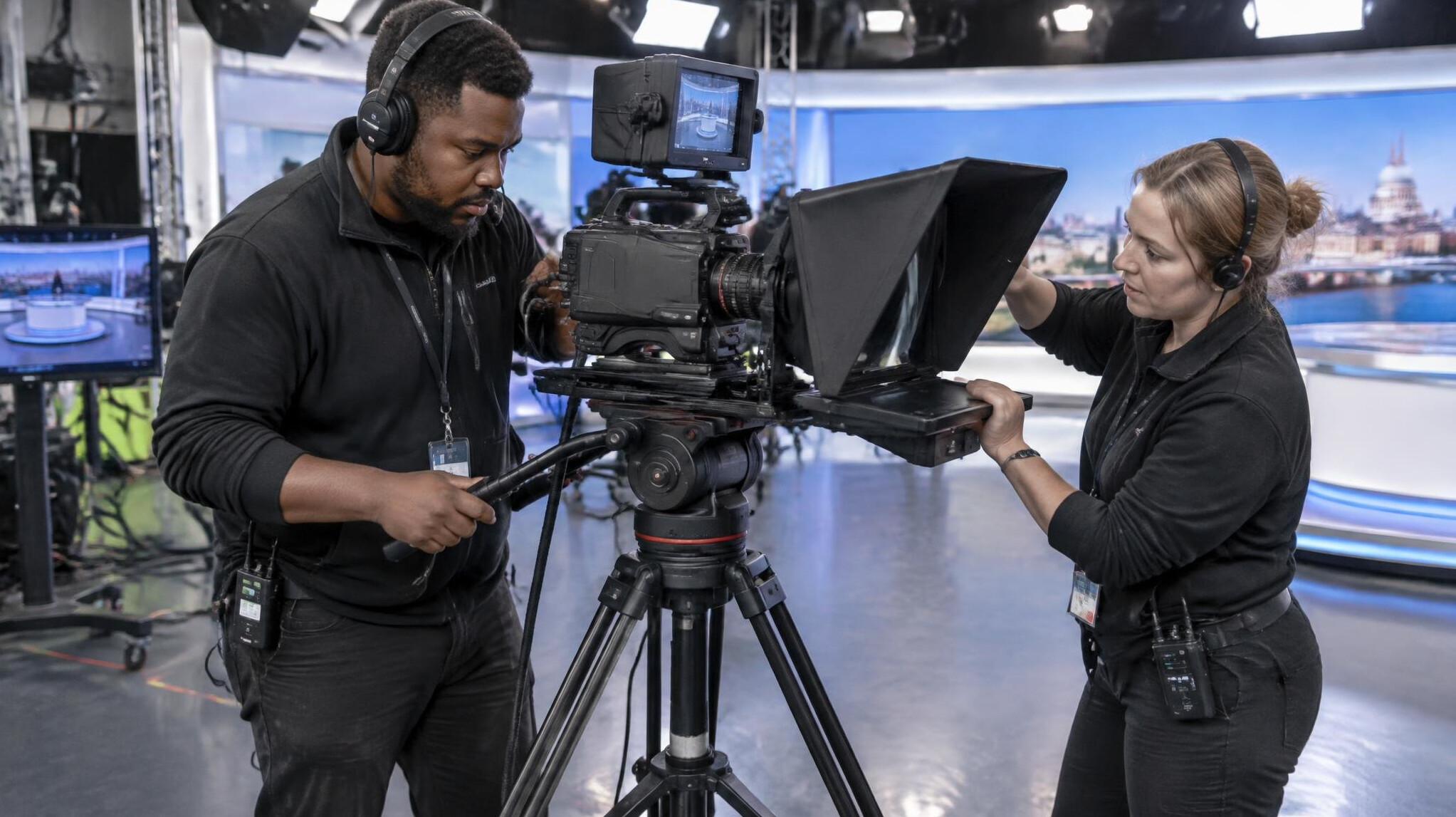 Crew setting up broadcast cameras before a live transmission